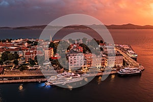 Zadar, Croatia - Aerial view of the Old Town of Zadar at dusk with mooring yachts, Cathedral of St. Anastasia photo