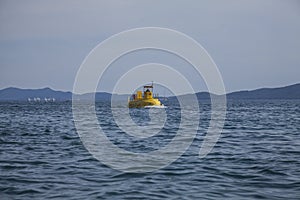 Zadar, Croatia - dark blue sea and a yellow boat.
