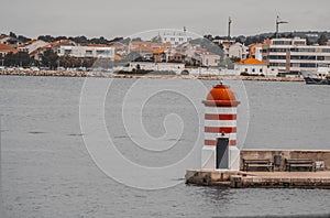 Zadar Port Lighthouse surrounded by the sea and buildings in Croatia