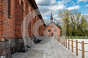 Zagare manor red brick stables on a sunny spring day, Lithuania