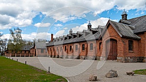 Zagare manor red brick stables on a sunny spring day, Lithuania