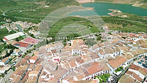 Zahara de la Sierra, Andalusia. Aerial view of whitewashed houses sporting rust-tiled roofs and wrought-iron window bars