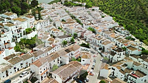 Zahara de la Sierra, Andalusia. Aerial view of whitewashed houses sporting rust-tiled roofs and wrought-iron window bars