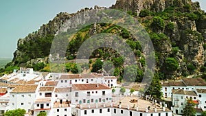 Zahara de la Sierra, Andalusia. Aerial view of whitewashed houses sporting rust-tiled roofs and wrought-iron window bars