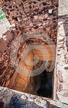 Zaida, Morocco - April 10, 2015. Abandoned stone water well in desert