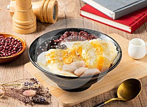 Zainaco grass jelly, mango, red beans and rice ball served in bowl isolated on table top view of asian food
