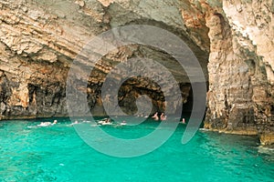 Zakynthos, Greece 28 July 2023. People swimming in the blue caves in Zakynthos island in Greece. Famous touristic destination.