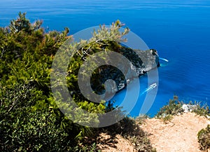 Zakynthos Island, Greece. View on boats, rocky shore and turquoise, crystal clear waters of Ionian Sea