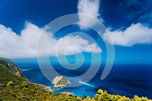 Zakynthos west fantastic coastal view. Lonely white cliff rock in sea. White tourist ship sailing full speed on open