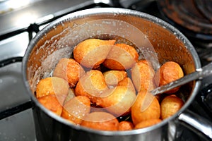 Zalabia in a stainless steel pot, a type of middle eastern fried dough similar to that of a doughnut, a tasty dessert