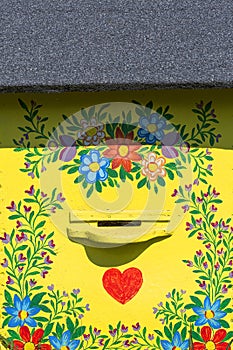 Old wooden beehives decorated with a hand painted colorful flowers, Zalipie, Poland