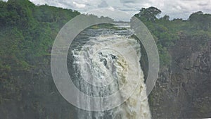 The Zambezi River flows along a rocky bed and collapses into a gorge. photo