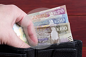 Zambian money in the black wallet
