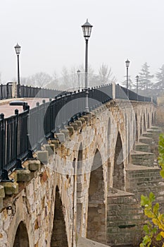 Stone bridge of Zamora and the Douro river in a foogy day photo