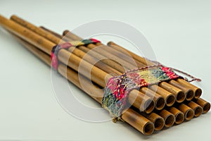 ZampoÃÂ±a. Close-up view of Peruvian pan flute isolated on a white background. Concept musical instruments