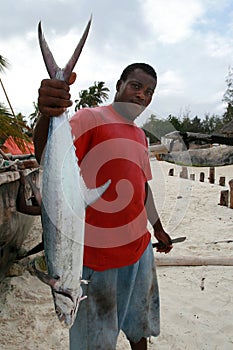 Zanzibar dark-skin fisherman holding mackerel