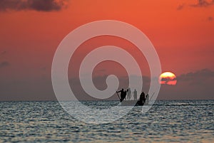 Zanzibar fishermans on the boat with sunset bacground