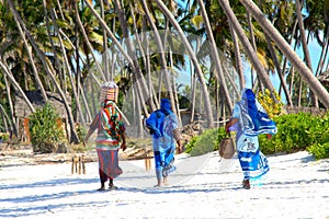 Zanzibar women on sandy beach photo