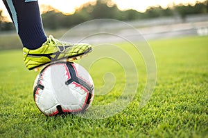 Zaporizhia, Ukraine. August 10, 2019. Football field soccer player in leggings. Close-up photo with the ball on the green grass of