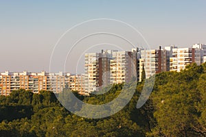 Zaragoza, Spain. February 16, 2023 Residential high-rise modern panel multistory houses near city park with green trees