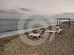 Zatoka, Odessa, Ukraine - September 4, 2021: Beach scene after sunset. Beach loungers on the Black Sea coast. Mobile photography