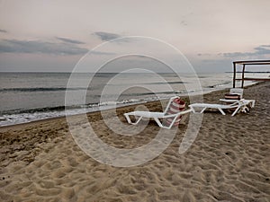 Zatoka, Odessa, Ukraine - September 4, 2021: Beach scene after sunset. Beach loungers on the Black Sea coast. Mobile photography