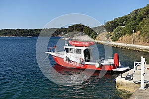 Zaton, Dubrovnik, Croatia - July 06, 2021: A fireboat designed for fighting shoreline and shipboard fires. Fireboat in Fire House