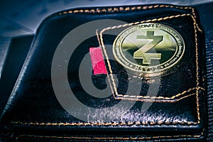 Zcash cryptocurrency coin on leather wallet.