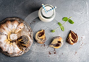 Zebra bundt cake cut into peices, milk in bottle and miny leaves