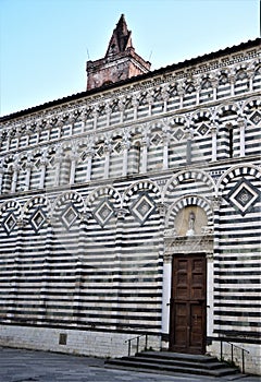 Zebra facades, with the tip of the bell tower peeping out, of the church of San Giovanni Fuorcivitas in the center of Pistoia.