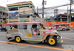 Zeepneys run on street in Manila, Philippines
