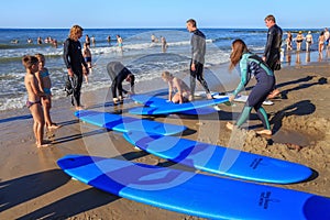 ZELENOGRADSK, KALININGRAD REGION, RUSSIA - JULY 29, 2017: Unknown surfers with surfboards standing on a sandy beach.