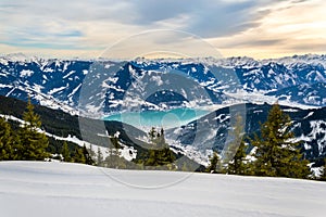 Zell am See at Zeller lake in winter. View from the Mountain Schmittenhohe, snowy slope of ski resort in the Alps