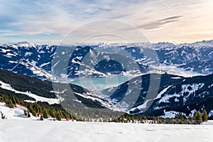 Zell am See at Zeller lake in winter. View from the Mountain Schmittenhohe, snowy slope of ski resort in the Alps