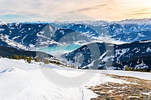 Zell am See at Zeller lake in winter. View from the Mountain Schmittenhohe, snowy slope of ski resort in the Alps