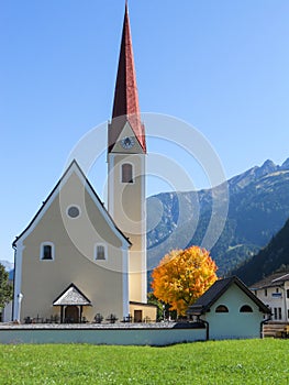 Zell am Ziller, Tyrol, Austria. September 2012. The church of Zell am Ziller with a golden autumn tree, Tyrol, Austria.
