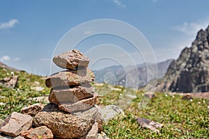 Zen balanced stones stack in high mountains. Pyramidal of stones against the backdrop of a picturesque mountain valley