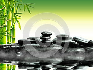 Zen basalt stones with green bamboo on water. Spa and Wellness concept.