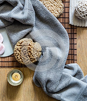 Zen bath with candle, fresh towel and natural sponge