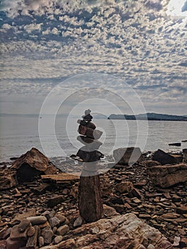 Zen.  A big pyramid of small stones on the seashore at Adriatic seaside in Piran. Meditation, balance, pray concept. tranquil