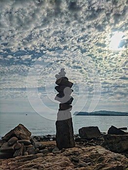 Zen.  A big pyramid of small stones on the seashore at Adriatic seaside in Piran. Meditation, balance, pray concept. tranquil