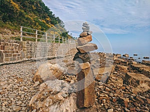 Zen.  A big pyramid of small stones on the seashore at Adriatic seaside in Piran. Meditation, balance, pray concept. tranquil