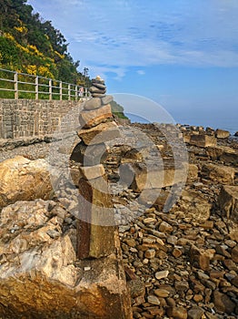 Zen.  A big pyramid of small stones on the seashore at Adriatic seaside in Piran. Meditation, balance, pray concept. tranquil