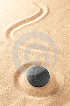 Zen Buddhism, medite and relax stone in raked Japanese sand garde