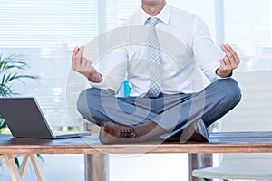 Zen businessman doing yoga meditation