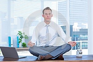 Zen businessman doing yoga meditation