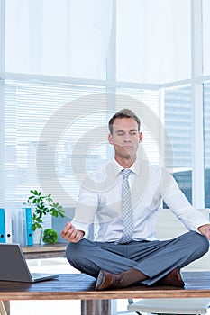 Zen businessman doing yoga meditation