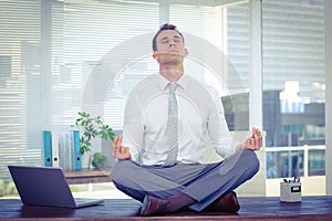 Zen businessman doing yoga meditation