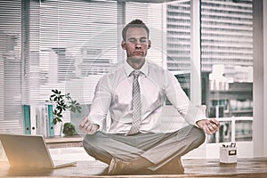 Zen businessman doing yoga meditation