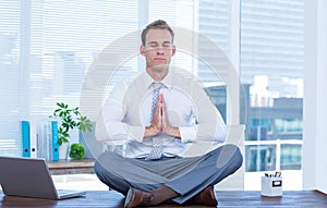 Zen businessman doing yoga meditation